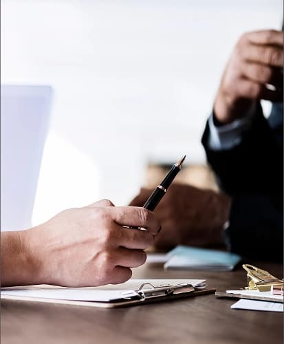 Hands signing a contract with Easy Staff, symbolizing a new business agreement.